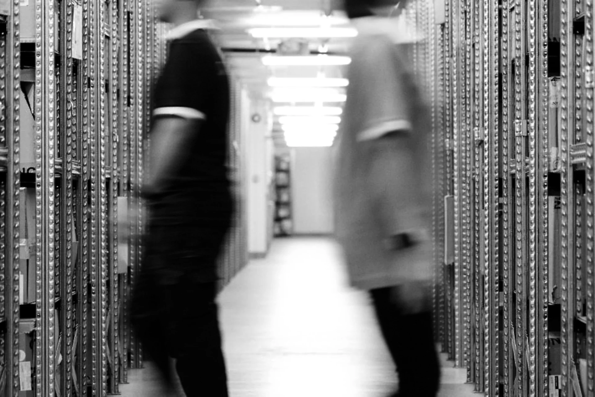 Operators moving between high-density storage aisles inside a Snatt fashion logistics hub